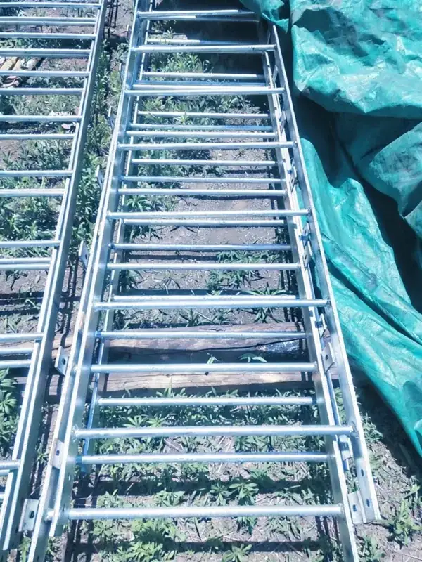Fixed ladder rung spacing and standoff bracket detail on a galvanized steel ladder